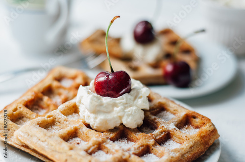 Breakfast with wholegrain waffles and whipped cream photo