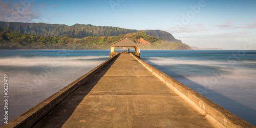 Pier at Hanalei bay, kauai. Long exposure with early morning sunlight photo