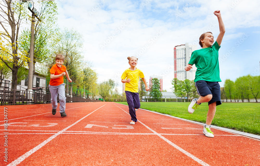 Obraz premium Boys and girl in colorful uniforms run marathon