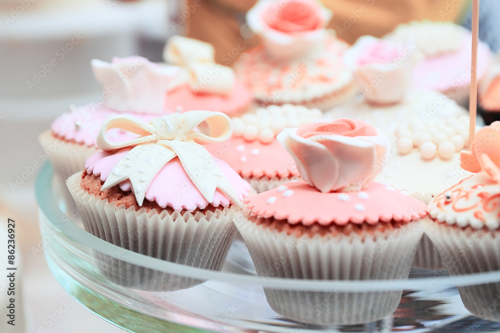 Tasty pink cakes on glass dish Tasty pink cakes on glass dish