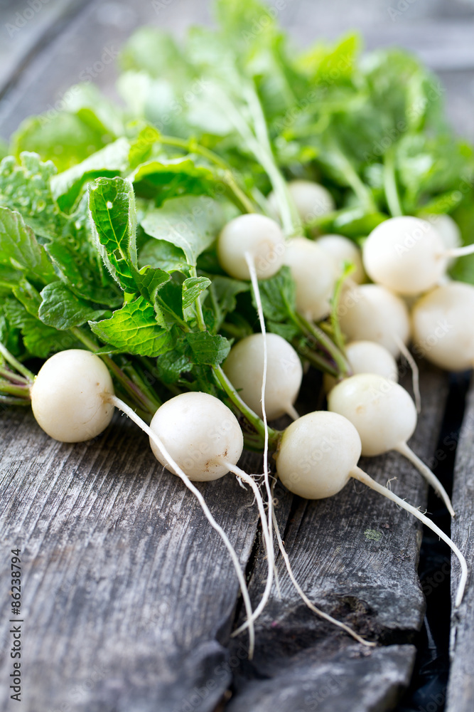 white radishes on wooden surface white radishes on wooden surface