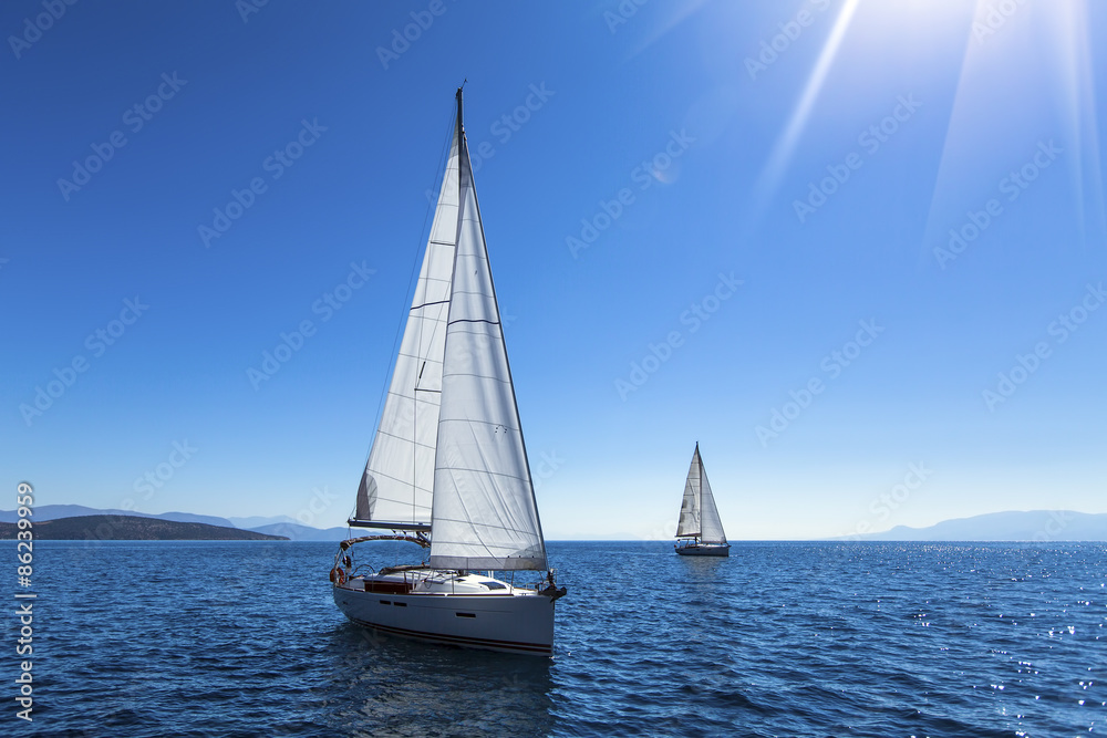 Sailing yacht race. Ship yachts with white sails in the open Sea. Luxury boats.