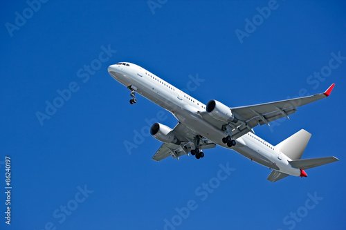 flying airplane on blue sky background