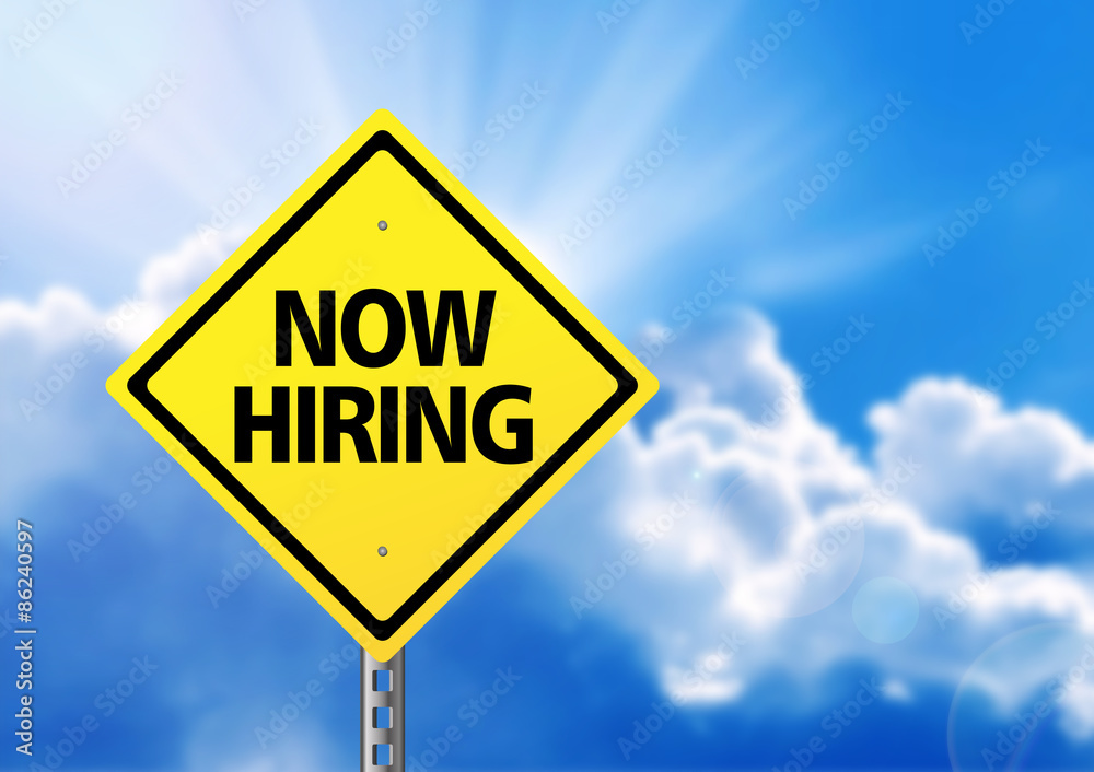 Yellow road sign with text now hiring. Yellow road sign with text now hiring.