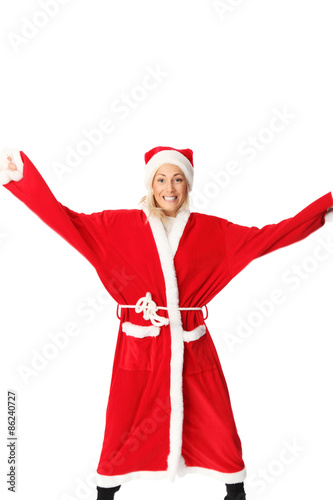 Crazy santa claus in blonde hair jumping. Wearing a red suit and hat
