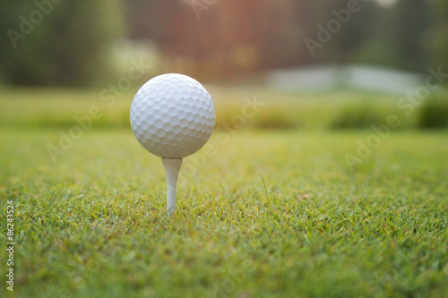 Close up of golf ball on tee at sundown