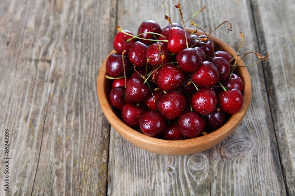 Ripe cherry in a wooden bowl Ripe cherry in a wooden bowl