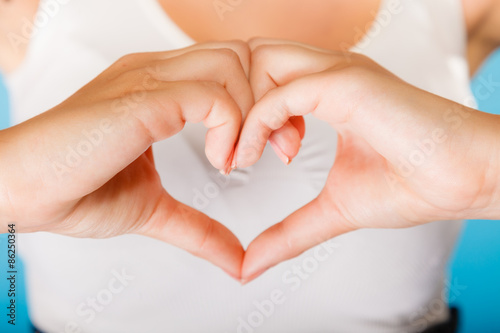 Girl hands with heart sign.