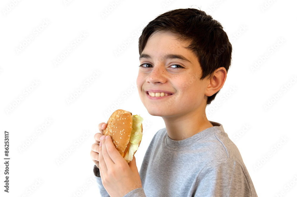 Boy eating a burger and smiling. Cute caucasian kid eating a hamburger. Isolated on white. Boy eating a burger and smiling. Cute caucasian kid eating a hamburger. Isolated on white.