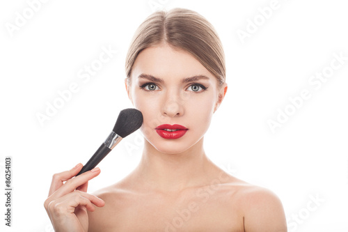 Beauty Girl with Makeup Brush. Beautiful Face. Makeover. Perfect Skin. Applying Makeup 