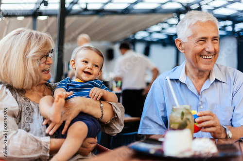Grandparents With Their Grandson At Cafe