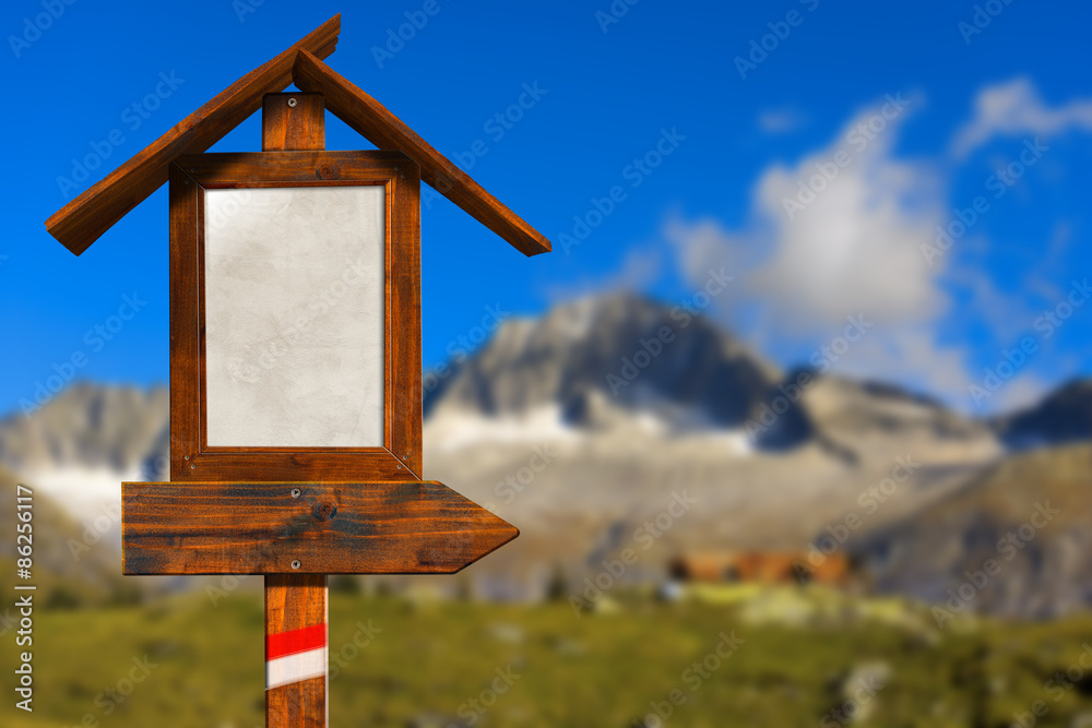 Wooden Directional Sign in Mountain / Empty wooden directional sign with roof in a blurred mountain landscape