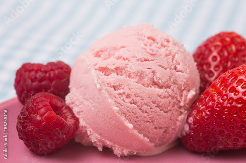 Scoop of raspberry ice cream with strawberries