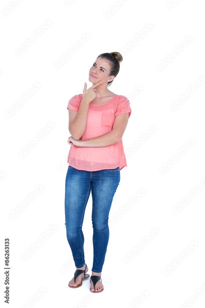 Thoughtful pretty casual brunette standing with hand on chin Thoughtful pretty casual brunette standing with hand on chin