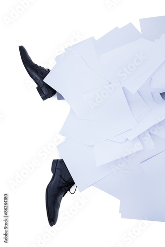 businessman burried under piece of paper