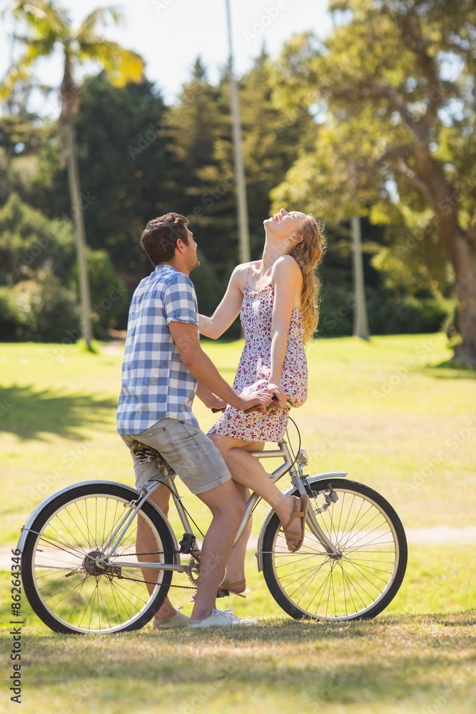 Young couple on a bike ride in the park