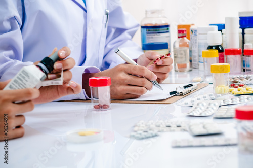 two pharmacists preparing prescription and medicine box
