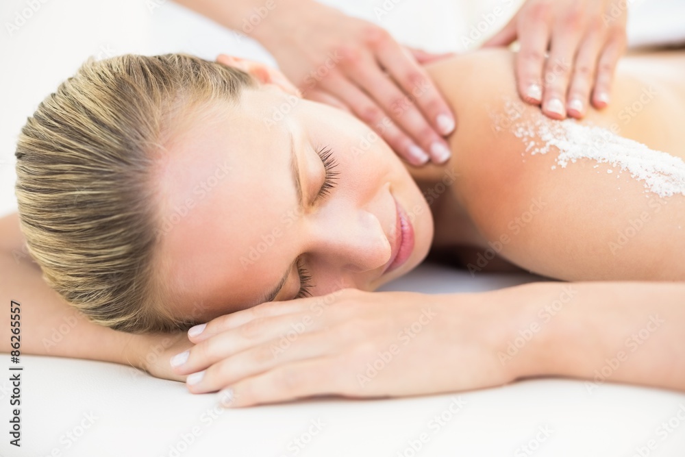 Beautiful woman receiving stone massage at spa center Beautiful woman receiving stone massage at spa center