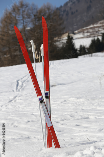 red cross country skiing in winter photo