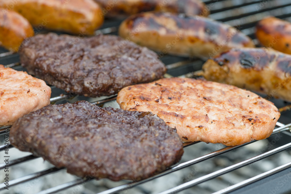 BBQ - Exotic meat burgers and sausages on a lit barbecue (kangaroo, crocodile and wild boar).
BBQ - Exotic meat burgers and sausages on a lit barbecue (kangaroo, crocodile and wild boar).