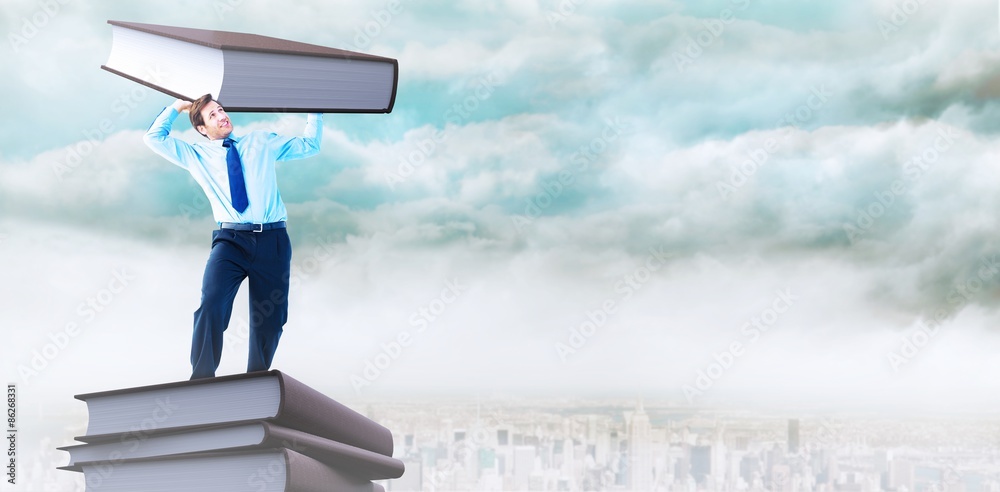 Composite image of focused businessman lifting up something heavy