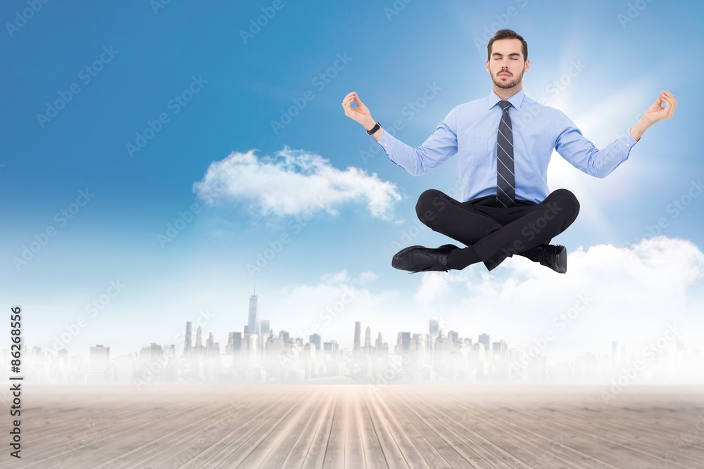 Composite image of calm businessman sitting in lotus pose Composite image of calm businessman sitting in lotus pose