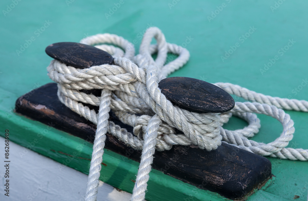 Fototapeta premium Knots and ropes on a moored ship in harbor