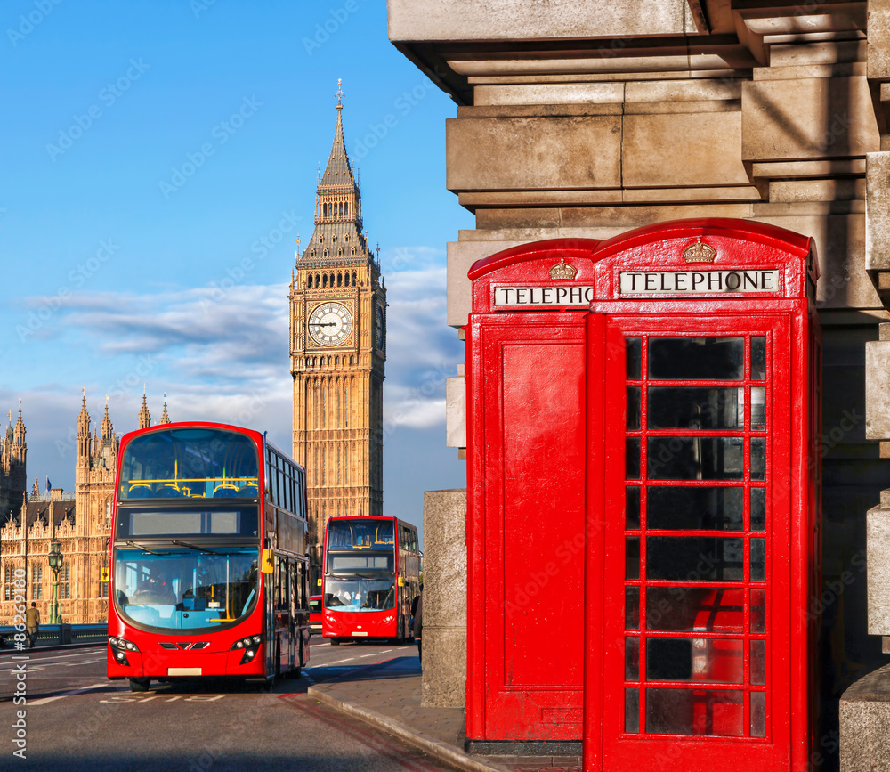 London with red buses against Big Ben in England, UK