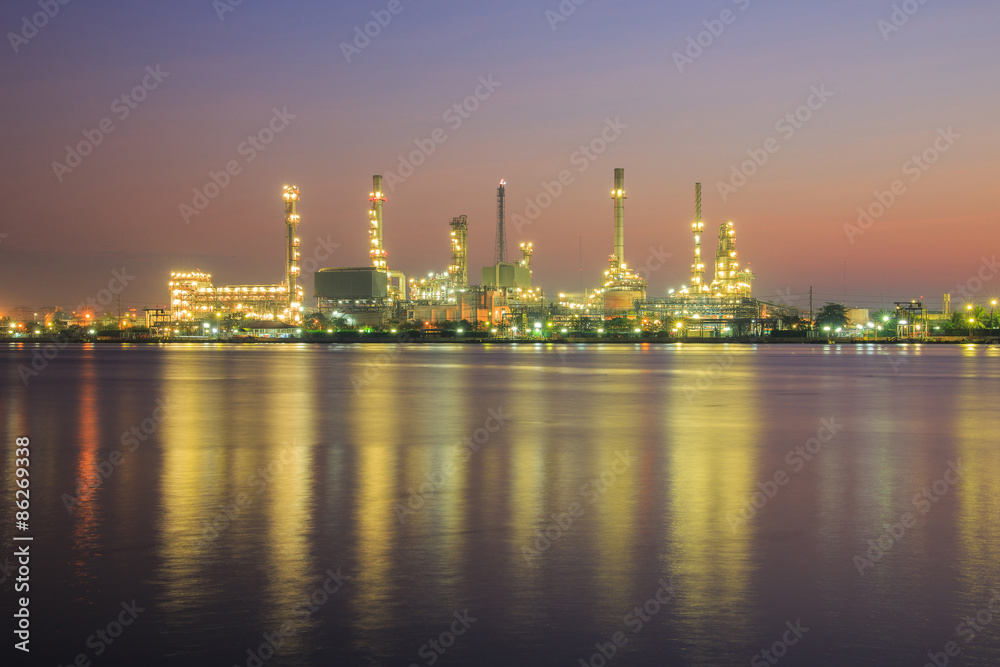 Oil refinery factory in silhouette and sunrise sky