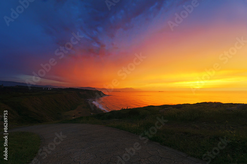 sunset with dramatic sky near Azkorri beach