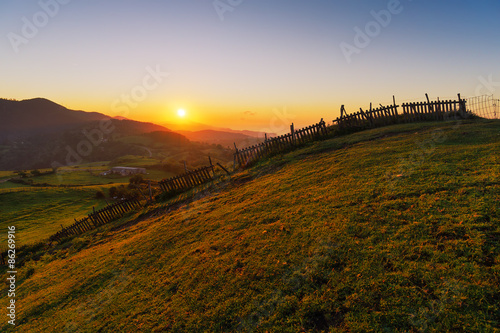 fence in the countryside at sunset