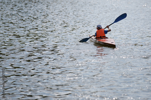 Silhouette of a man rowing in the canoe