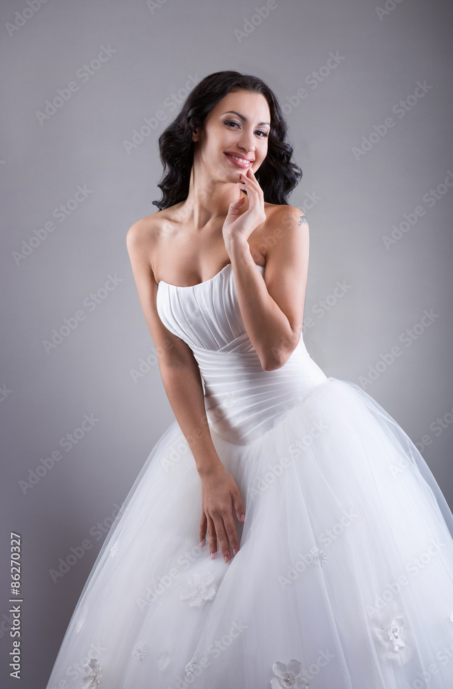 Fototapeta premium Smiling beautiful bride posing for photo