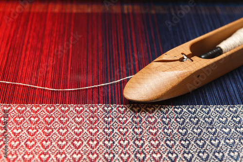Obraz na płótnie Weaving shuttle on the warp