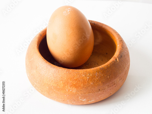 Light Brown of Chicken egg Placed in a brown pottery bowl.
