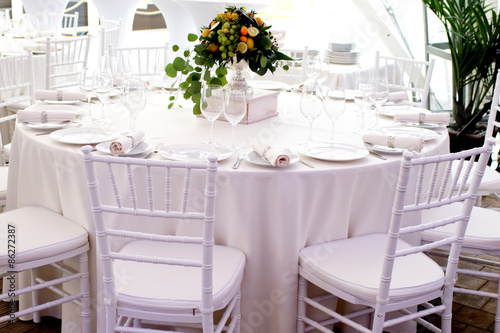 white chairs, white tablecloths on the tables in the restaurant © photoniko