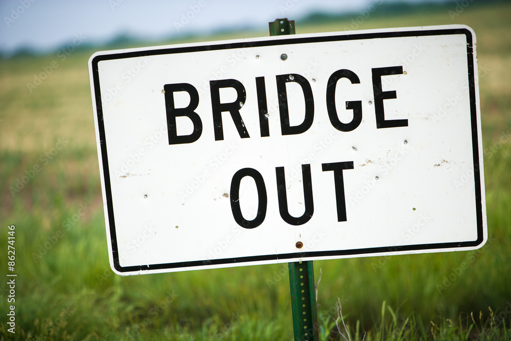 Bridge Out Sign With Bullet Holes and Green Pasture Bridge Out Sign With Bullet Holes and Green Pasture