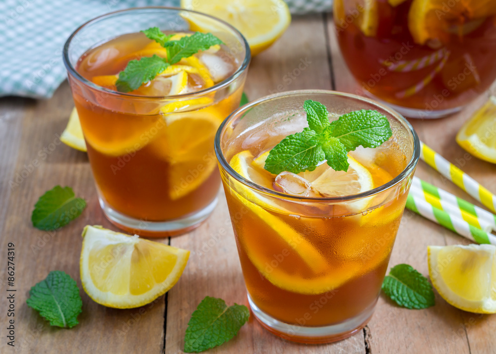 Refreshing homemade lemon iced tea on a wooden table Refreshing homemade lemon iced tea on a wooden table