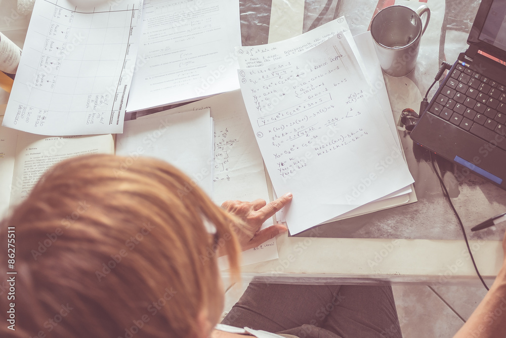 Naklejka premium Woman reading mathematics formulas, directly above