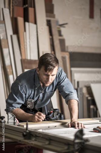 Young woodworker working in carpentry © Photographee.eu