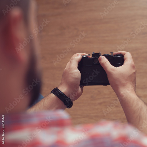 man holding vintage camera photo