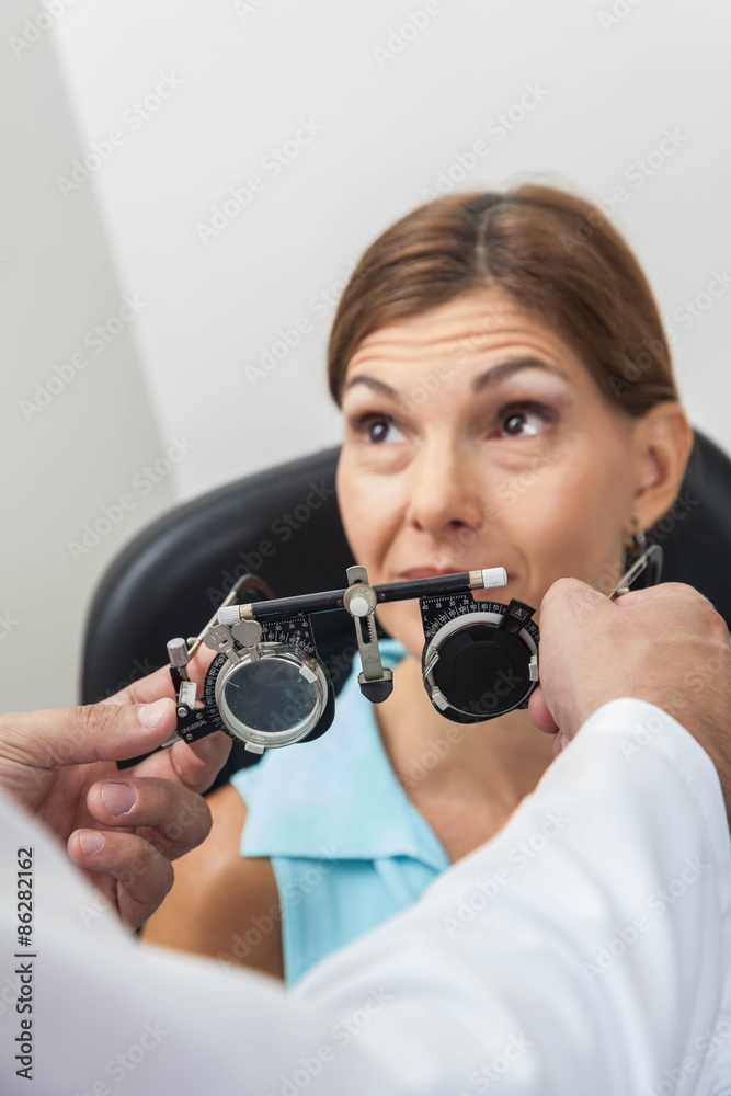 Ophthalmologist putting special lenses Ophthalmologist putting special lenses