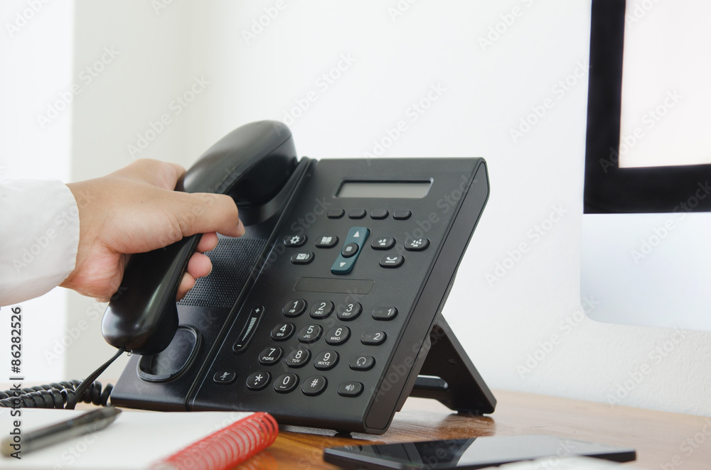 hand hold a telephone in the office for contact customer support hand hold a telephone in the office for contact customer support