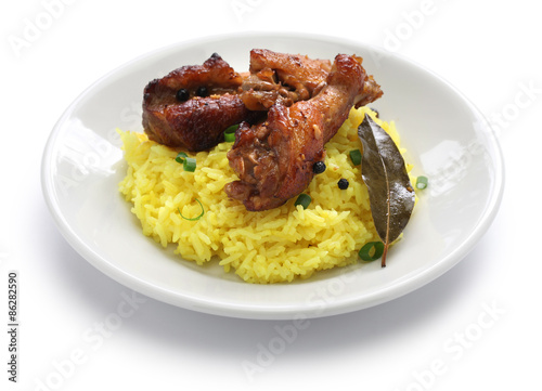 chicken and pork adobo over yellow rice, filipino food isolated on white background
