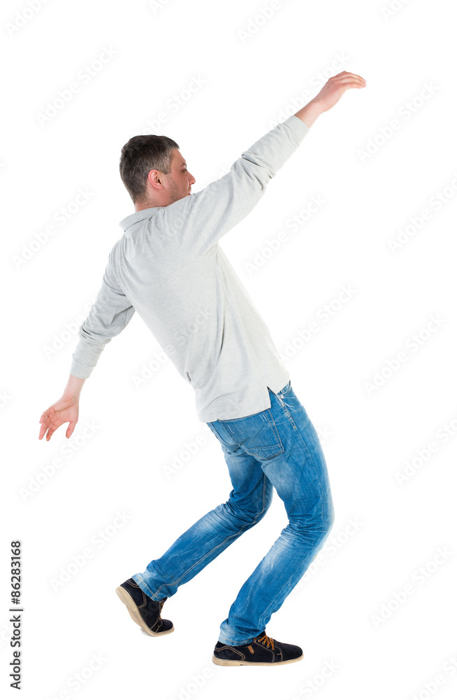 Back view man Balances waving his arms. Back view man Balances waving his arms.