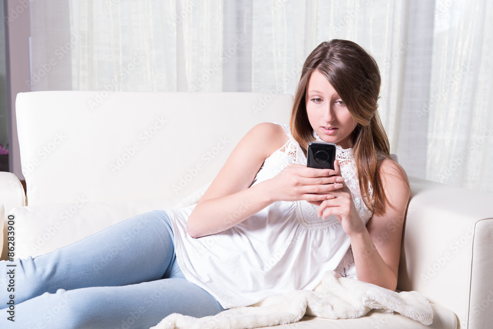attractive young girl reading a scary message on smartphone attractive young girl reading a scary message on smartphone