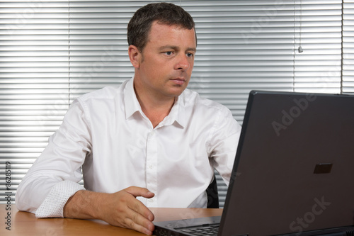 Charming man at work at his office