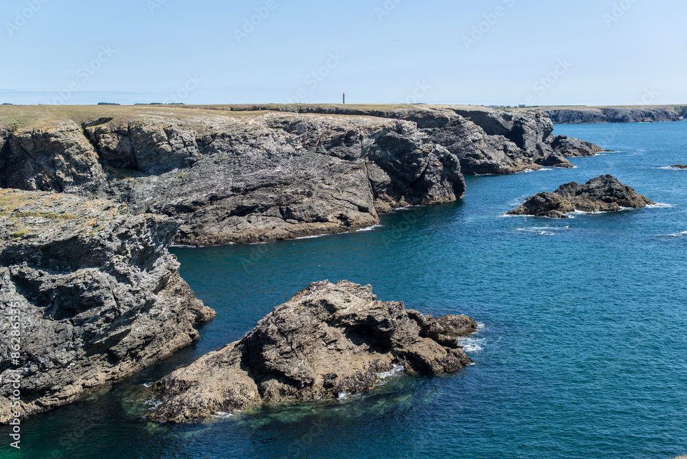 cliff of the wild coast of a brittany island dropping into the ocean