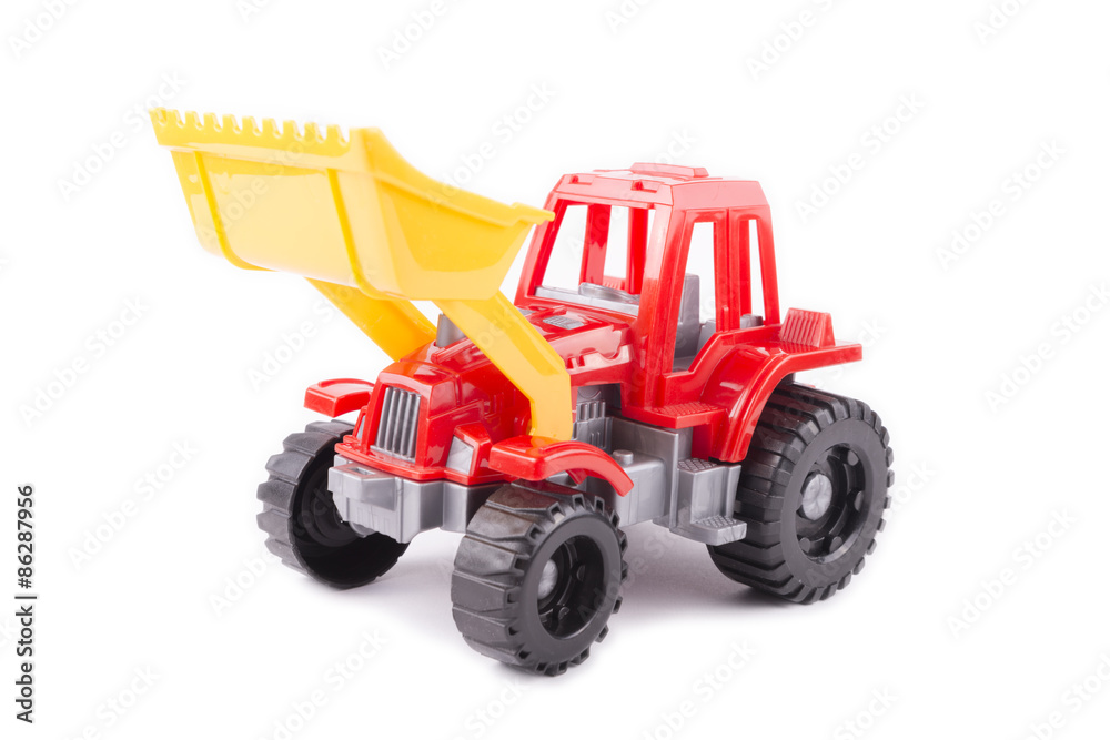 Obraz premium red toy tractor on a white background