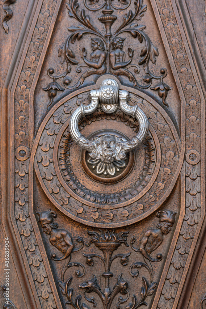 Ancient door with silver knocker in Granada, Spain